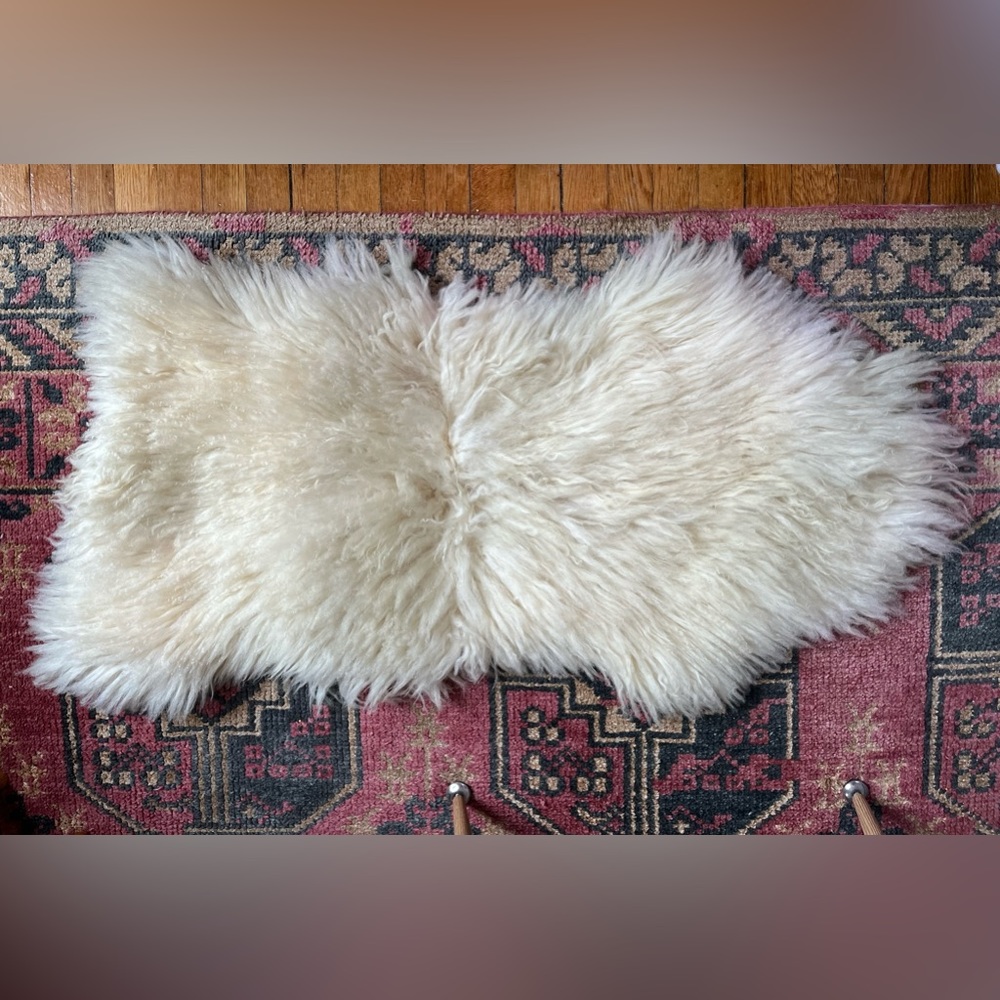 Fluffy natural long haired authentic sheep skin rug. 41 in L x 23 in max W